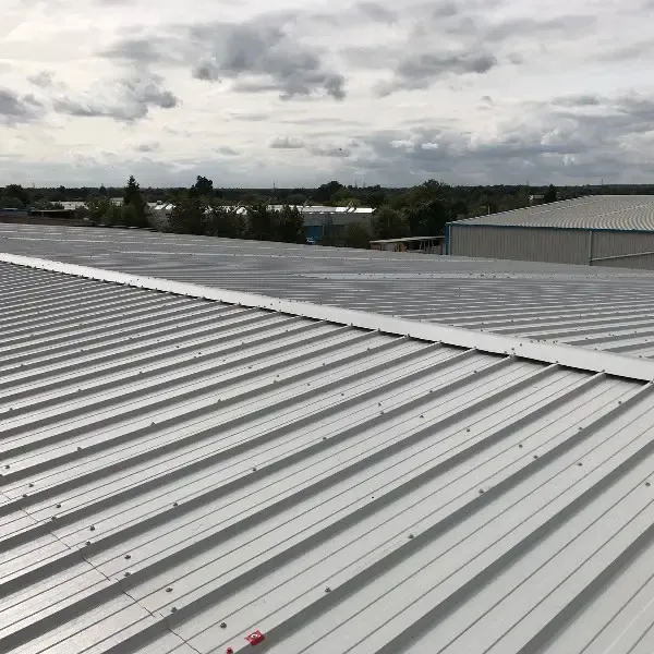 Commercial corrugated metal profile roof sheeting installed on an industrial building unit