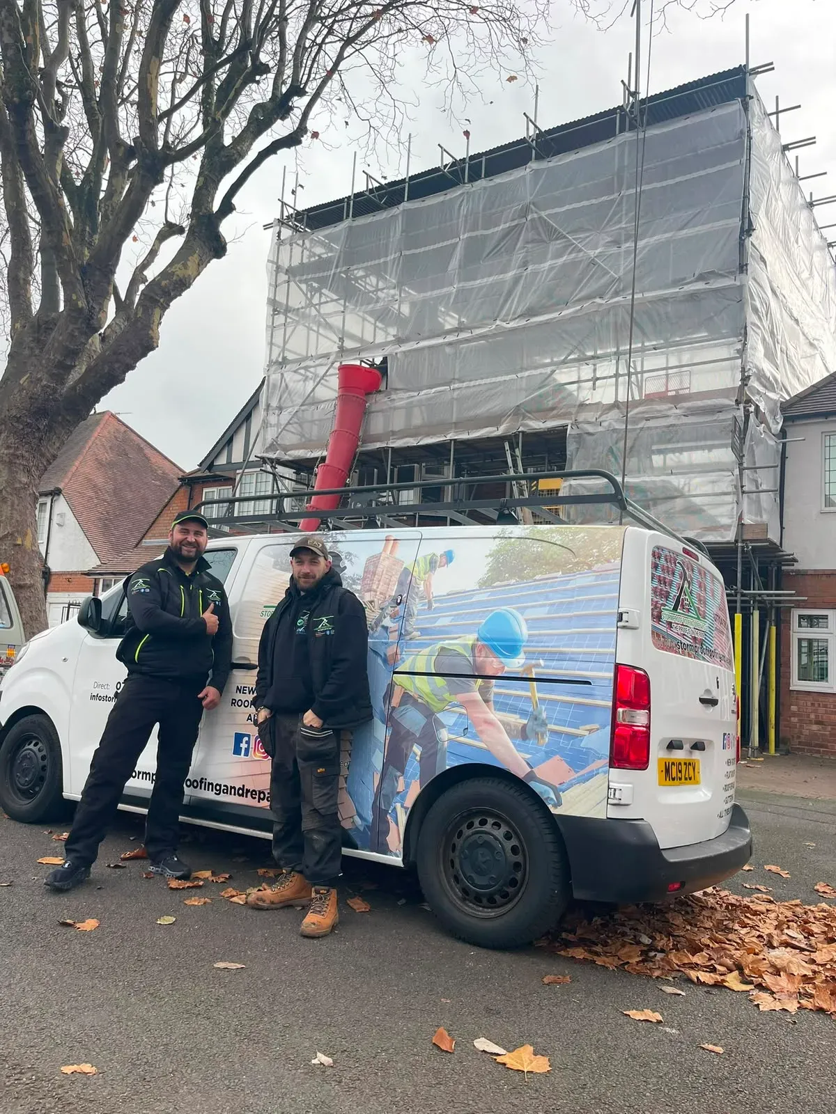 Anthony Lovell and a roofer from STORMPROOF ROOFING & REPAIRS LTD standing alongside their branded trade van on site