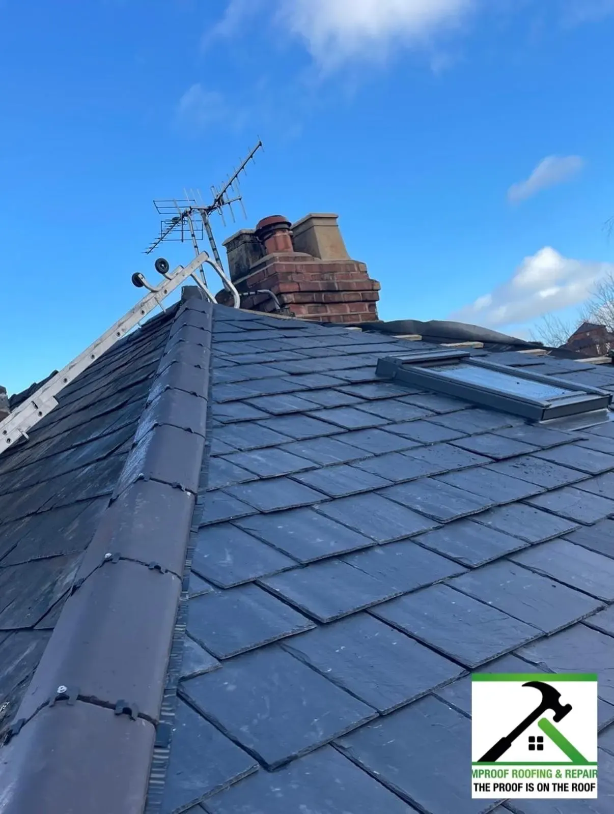Slate pitched roof repairs and dry hip installation showing chimney stack and roof window in Worcester