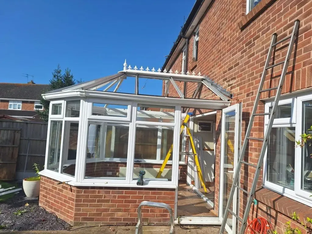 Conservatory roof replacement in progress showing the exposed frame prepared for warm roof installation
