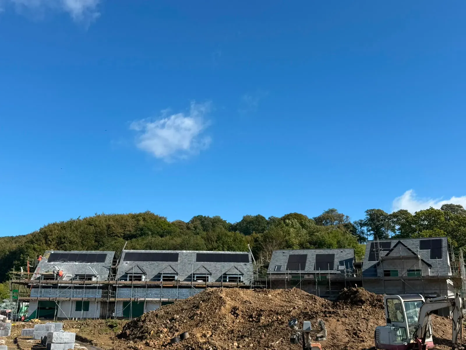 Pitched slate roof installation on newly built residential houses with dormers