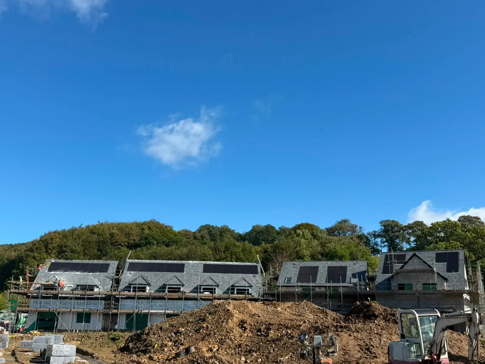 New pitched slate roof installations on residential new build homes with scaffolding