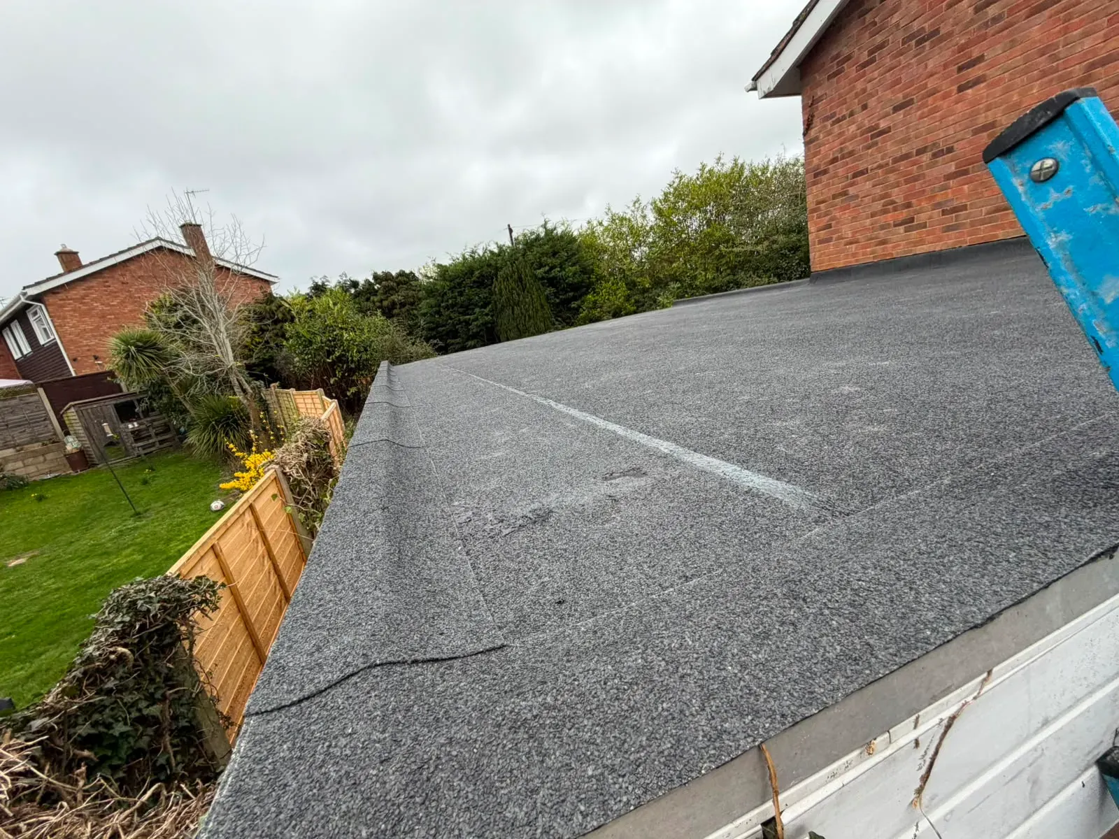 Newly completed mineral felt flat roof installation by STORMPROOF ROOFING & REPAIRS LTD