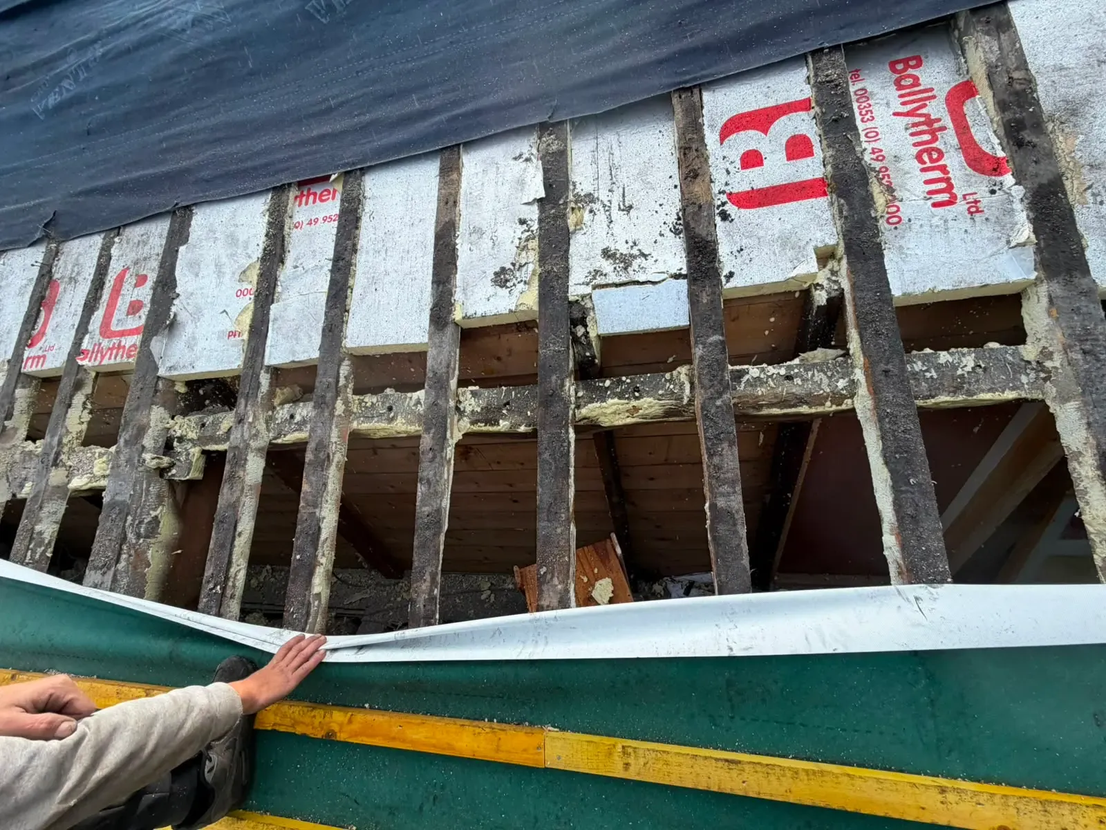 Exposed timber roof rafters and insulation undergoing inspection and weatherproofing repair in Worcester
