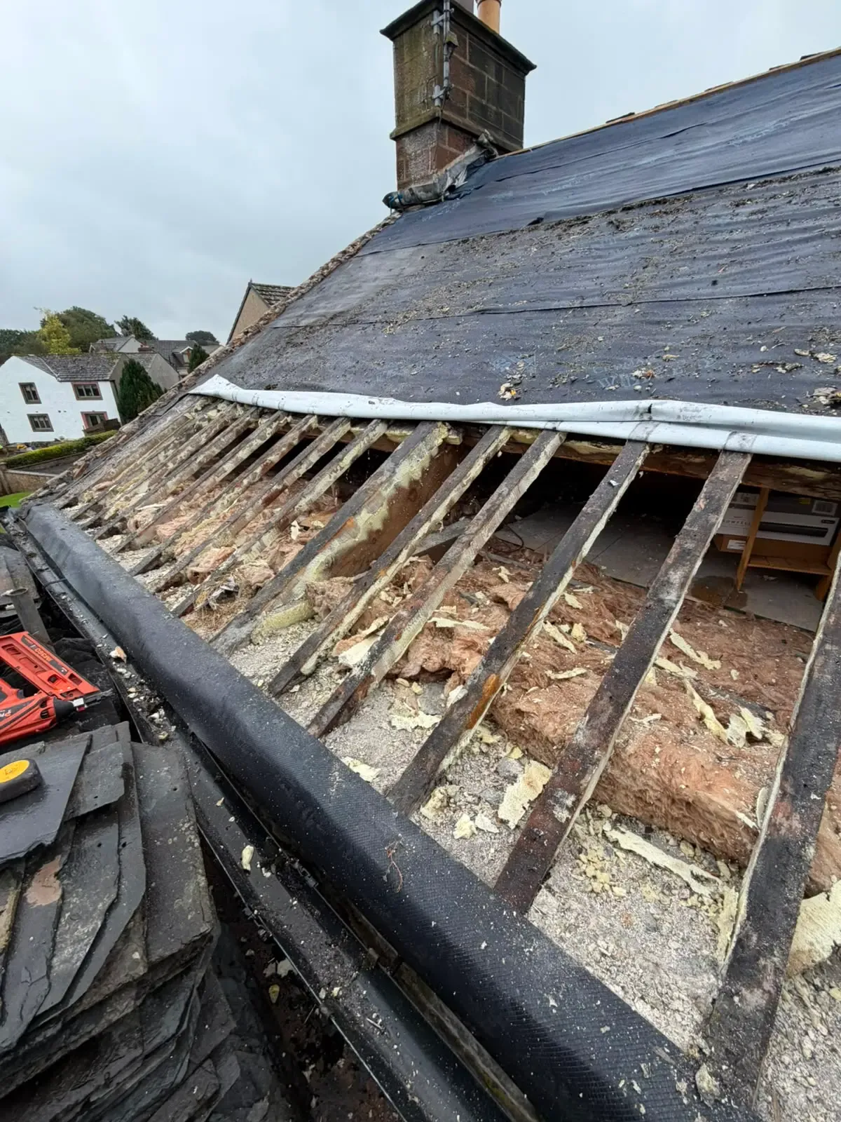 Exposed roof timbers and rafter inspection during pitched roof repairs and insulation removal in Worcester