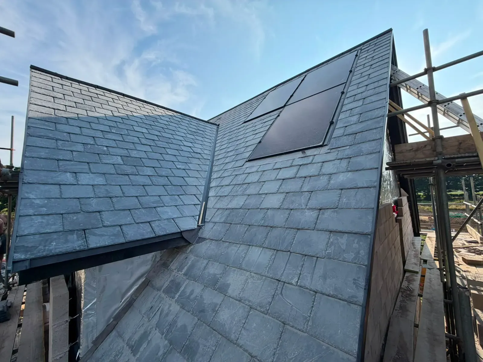 Newly installed pitched slate roof with valley and verge detail on a residential build in Worcestershire