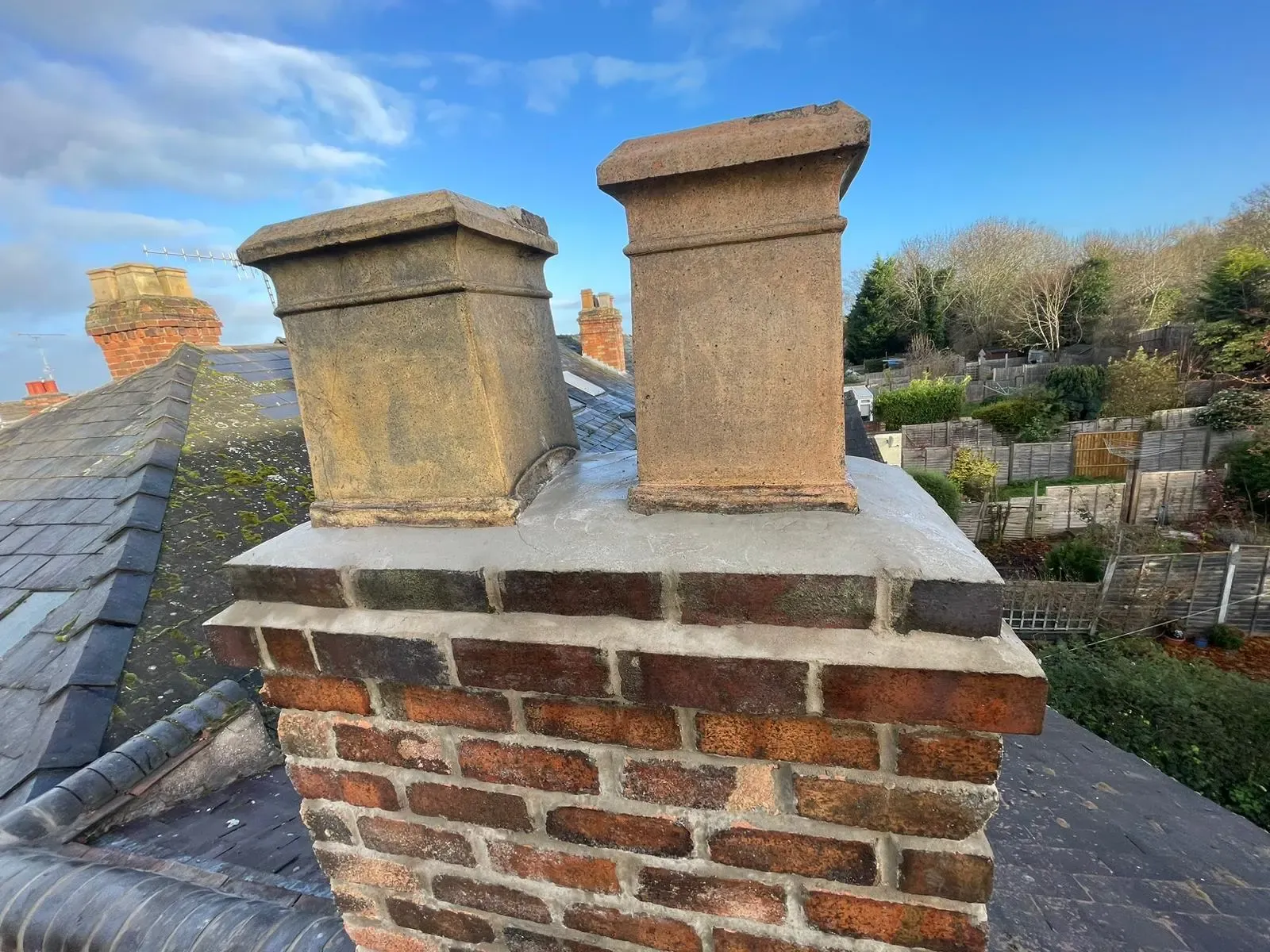 Repointed brick chimney stack with new cement flaunching and clay chimney pots in Worcester