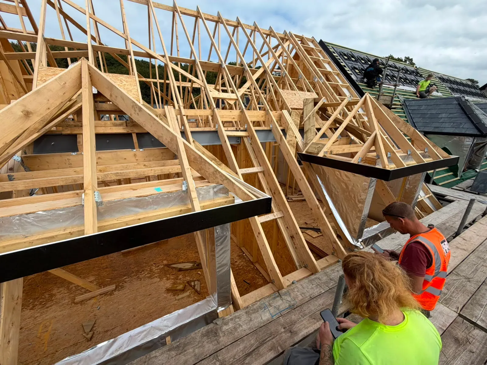 Structural timber roof truss and pitched roof installation with dormers