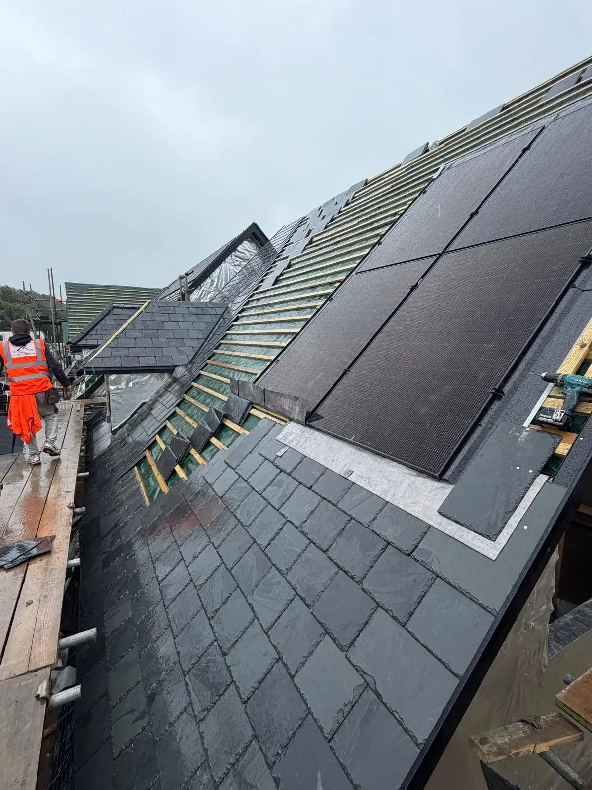Natural slate pitched roof installation in progress on a residential property