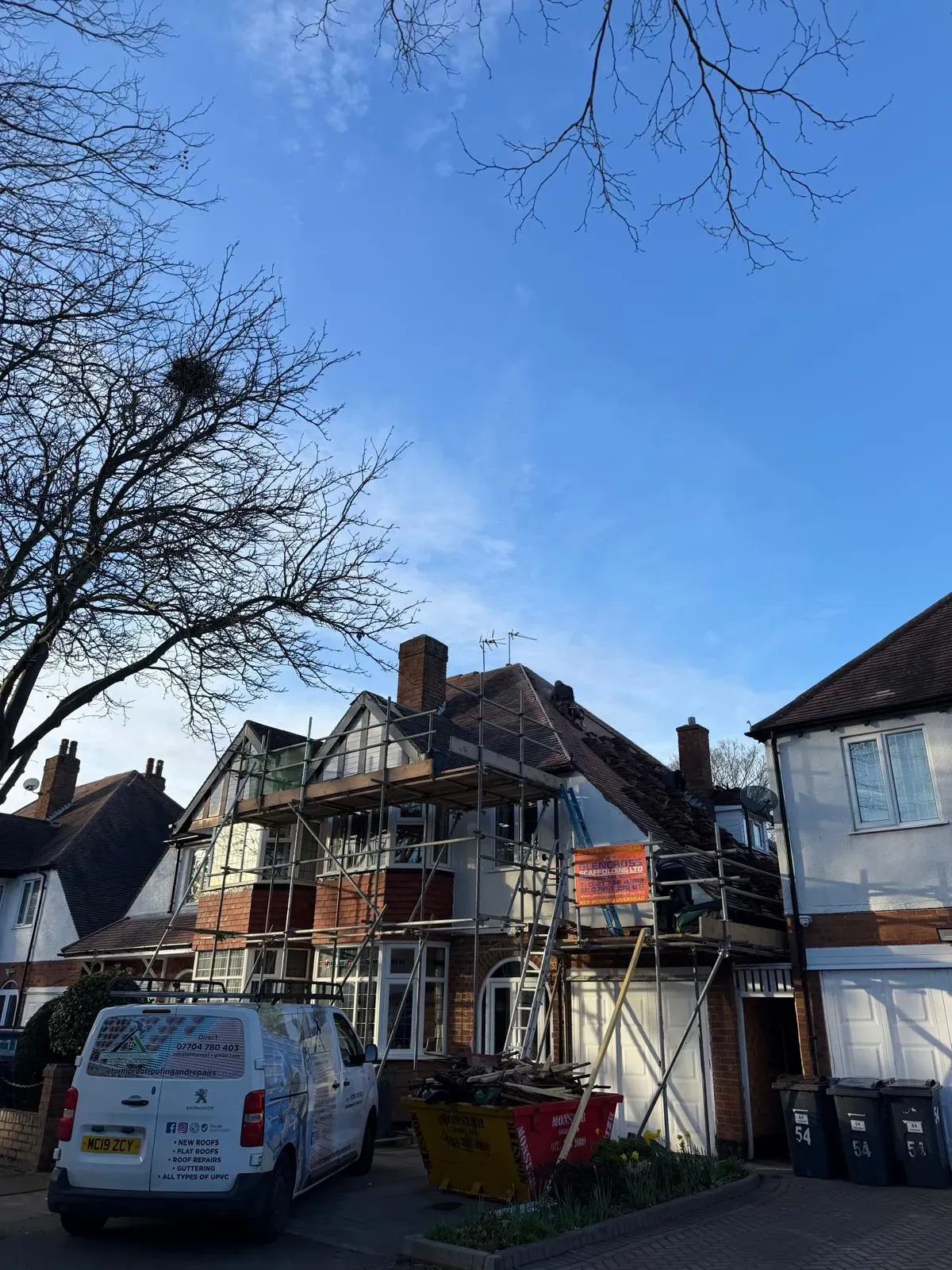 Pitched roof installation and tile replacement on a residential house with scaffolding and STORMPROOF ROOFING & REPAIRS LTD work van on site