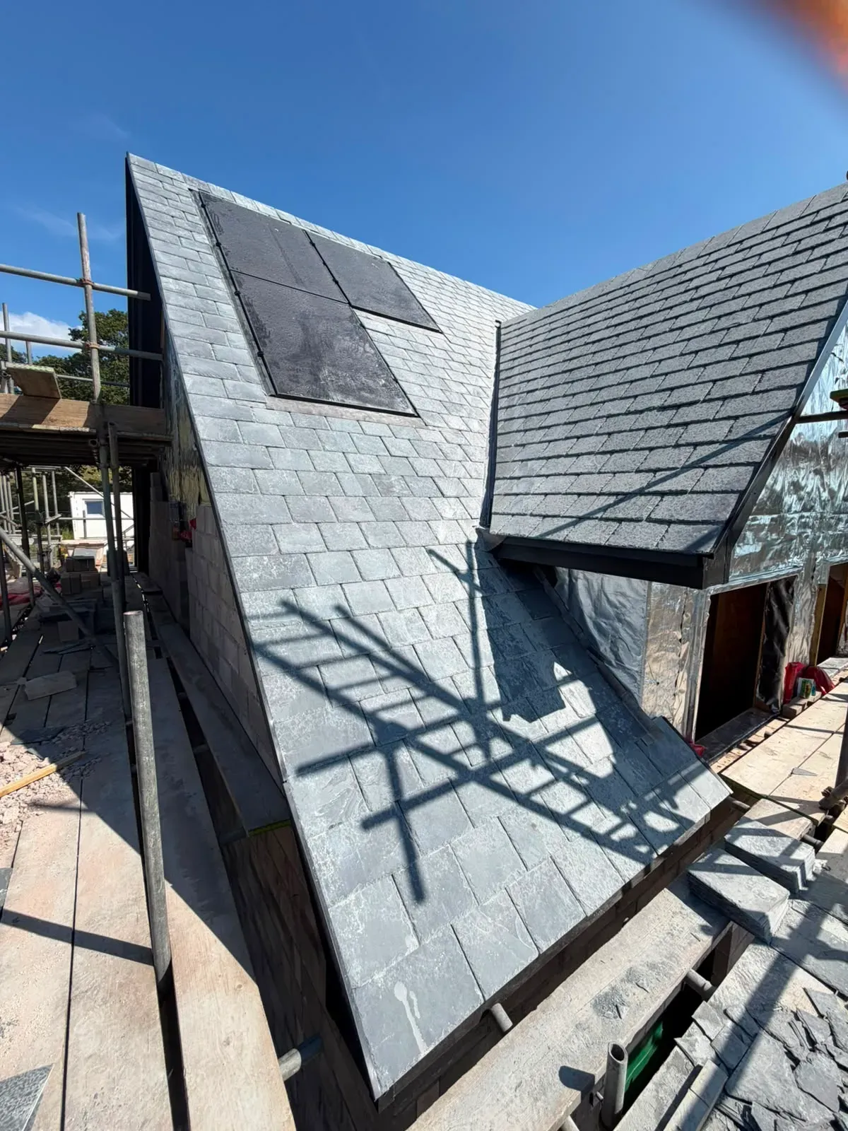 Pitched slate roof installation on a new build property in Worcester with scaffold access