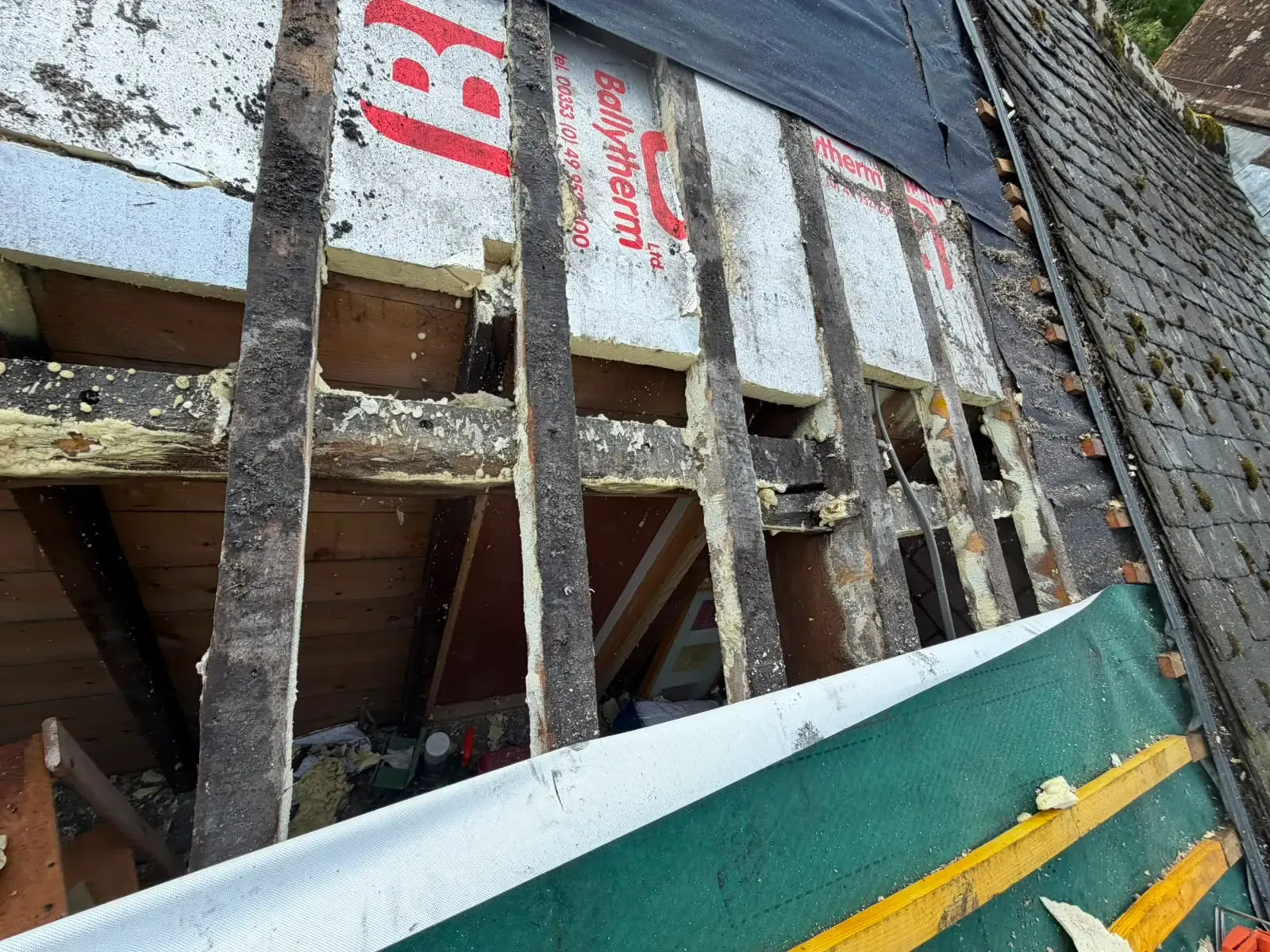 Exposed timber rafters and insulation during a pitched roof repair in Worcester