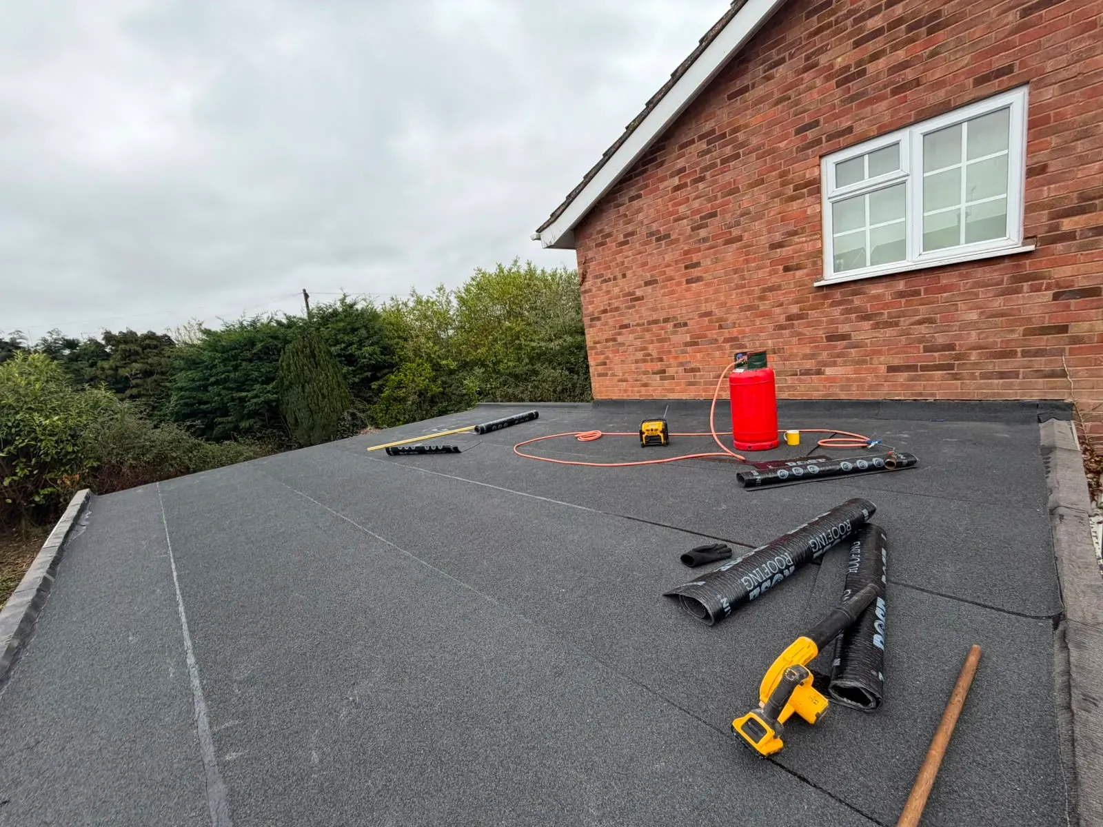 Torch-on mineral felt flat roof installation on a brick residential extension in Worcester