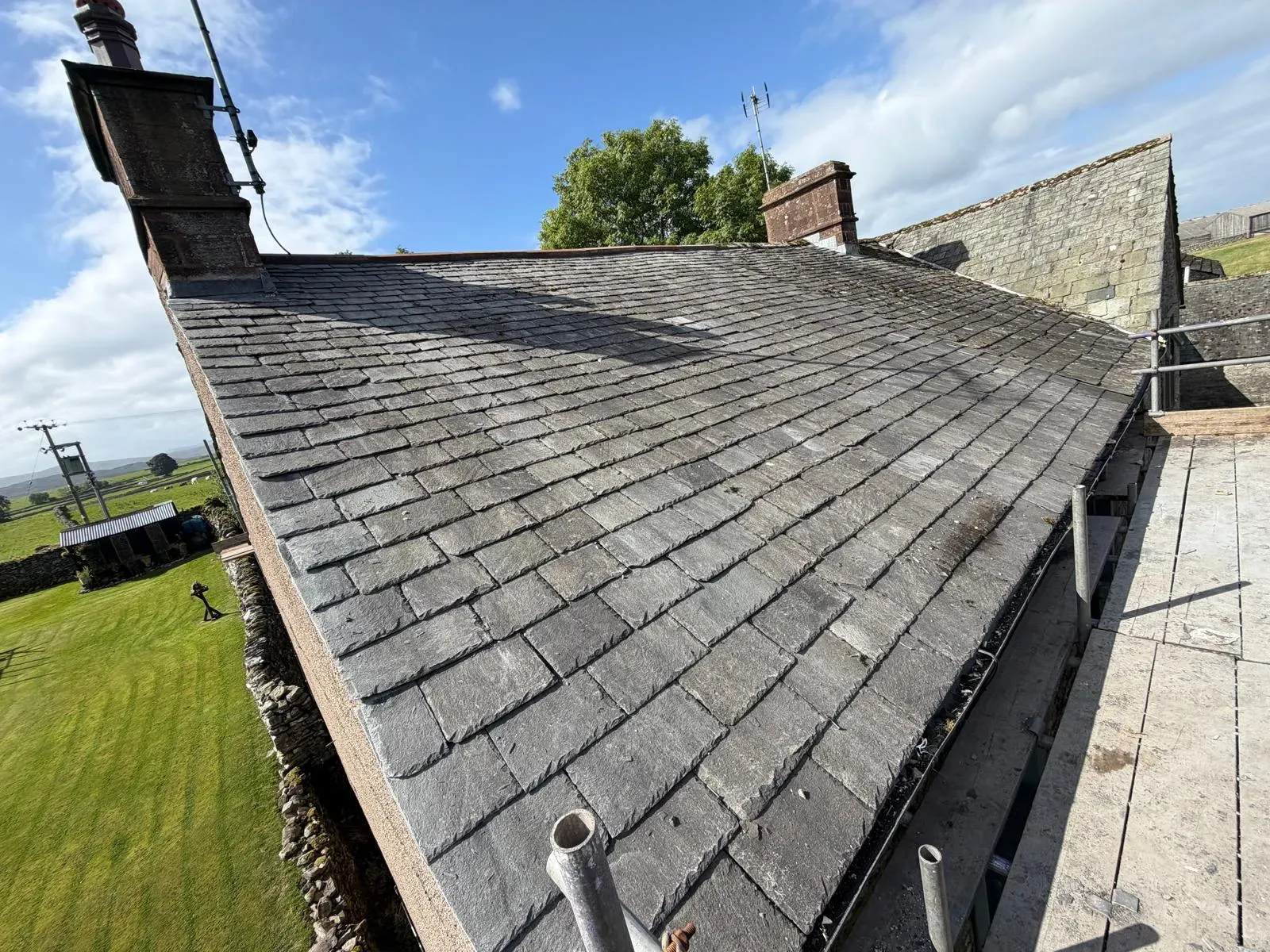 Natural slate pitched roof repairs and slating work with lead chimney flashing