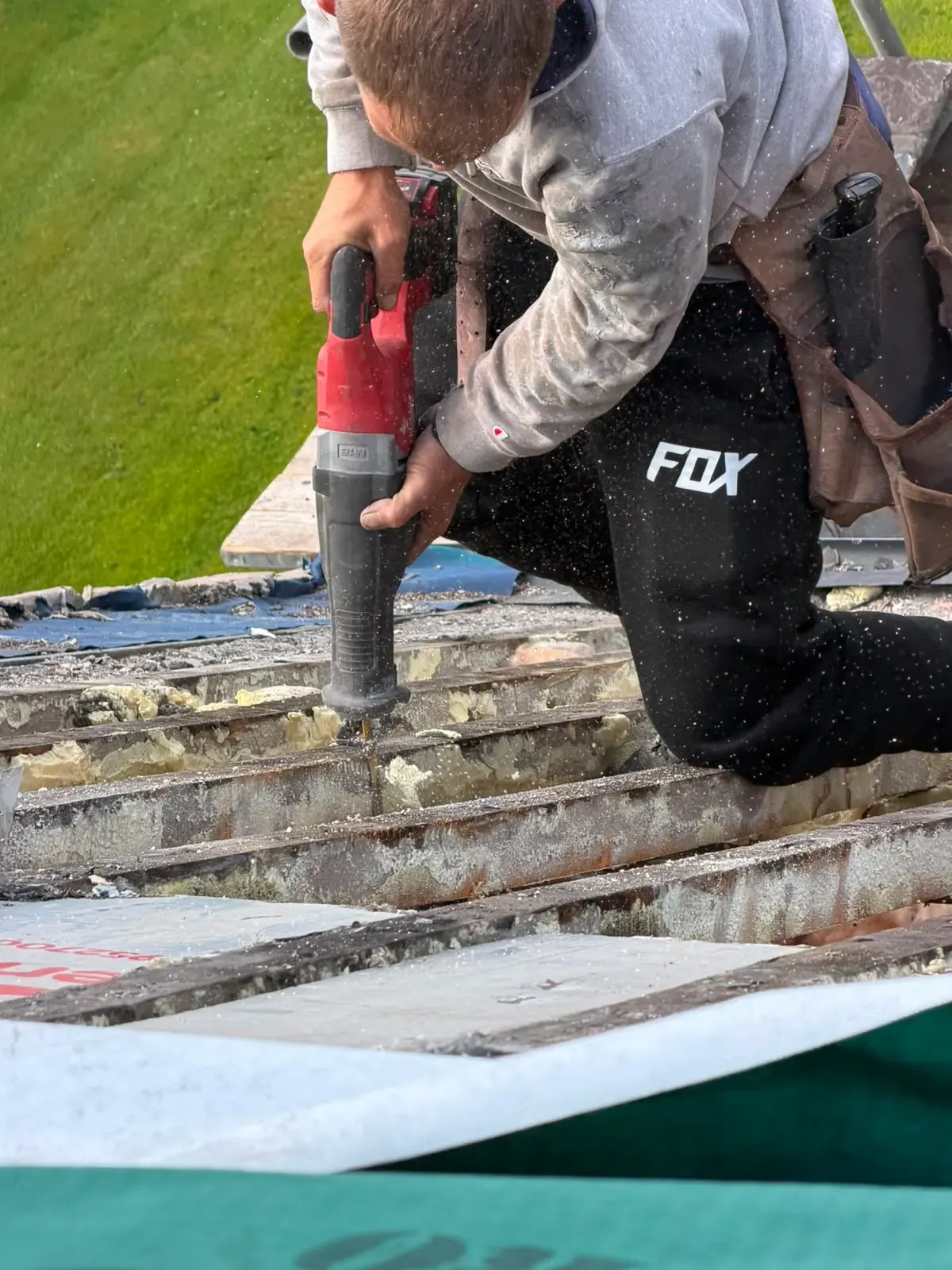 Roofer cutting and preparing roof timbers during a pitched roof repair in Worcester