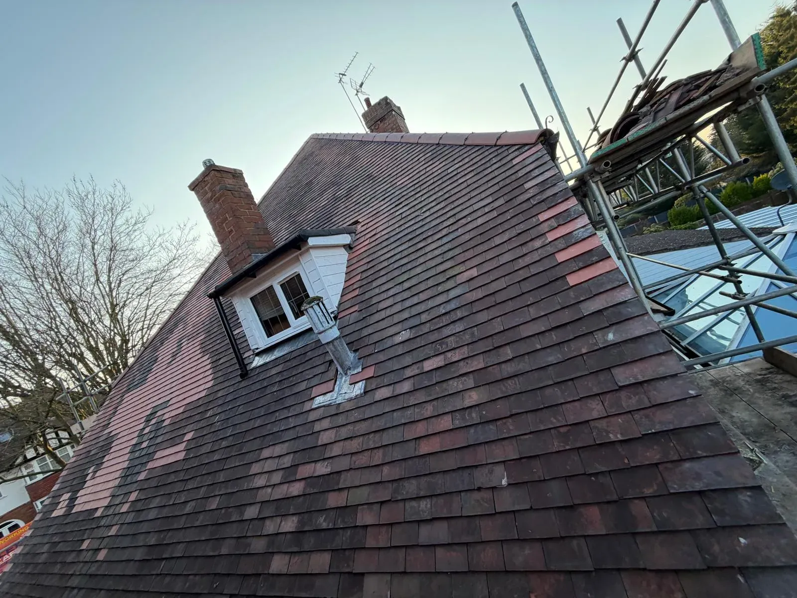 Pitched plain clay tile replacement and roof repairs with scaffolding on a residential home in Worcester