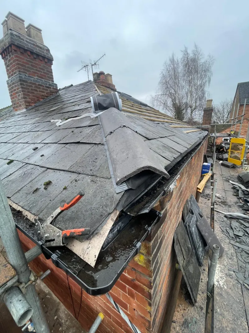 Dry ridge system and ridge tile installation on a pitched slate roof by STORMPROOF ROOFING & REPAIRS LTD